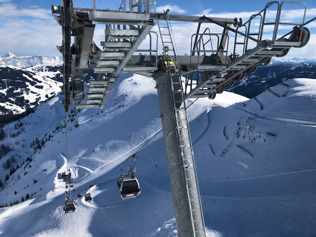 Cable cars travelling above the snowy Austrian Alps