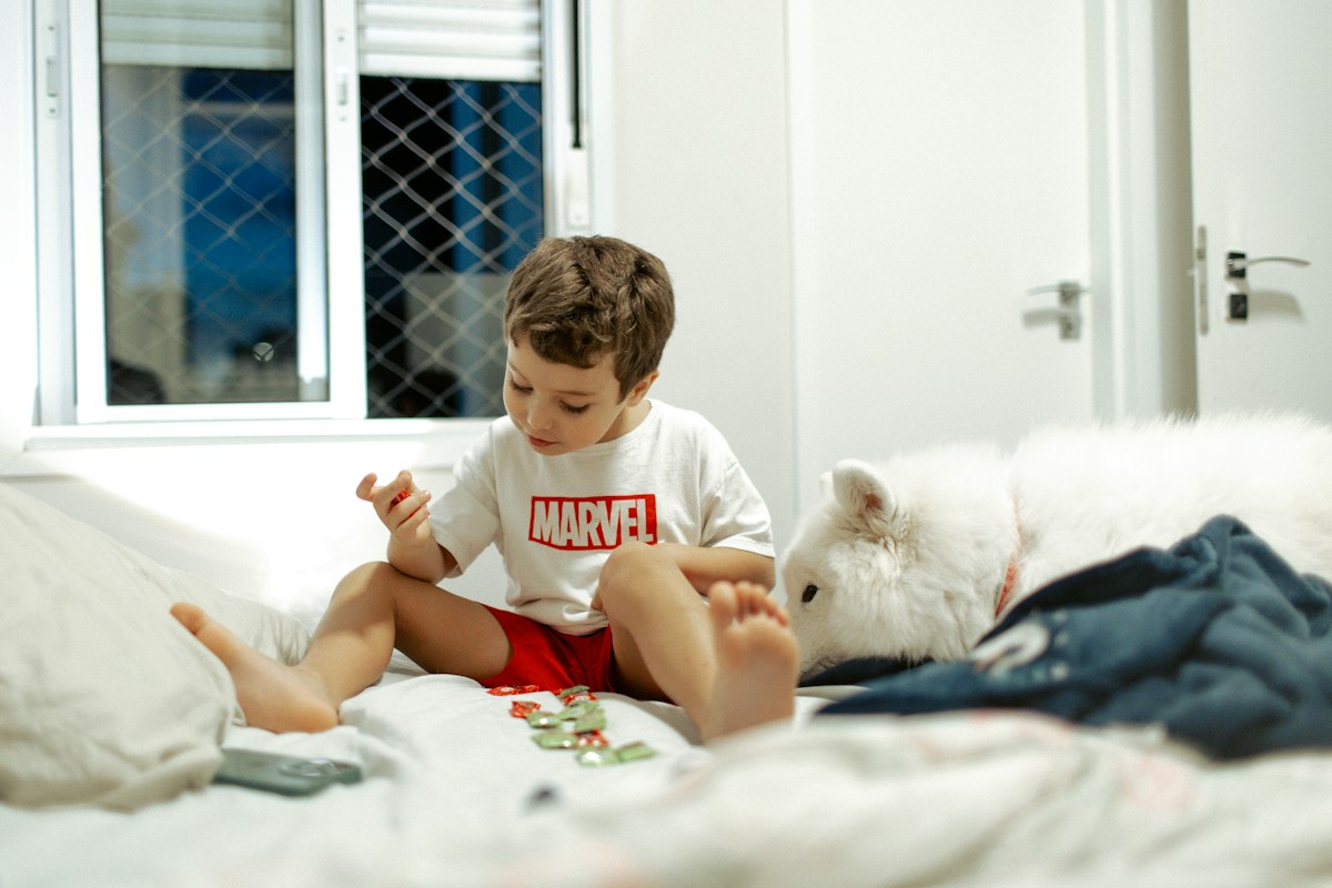 Baby playing with age-appropriate toys on a bed