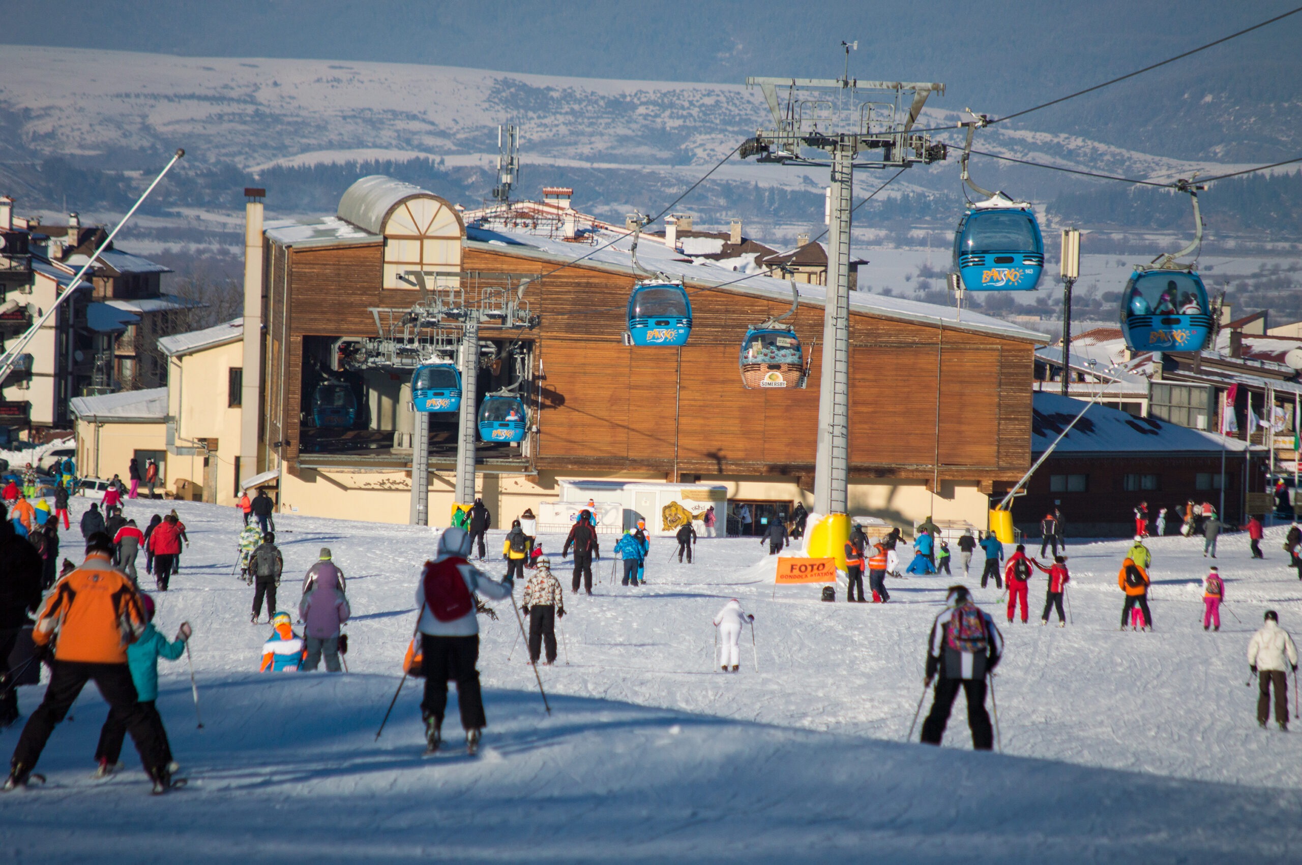 Bansko gondola station and skiers heading toward the Pirin Mountain ski area