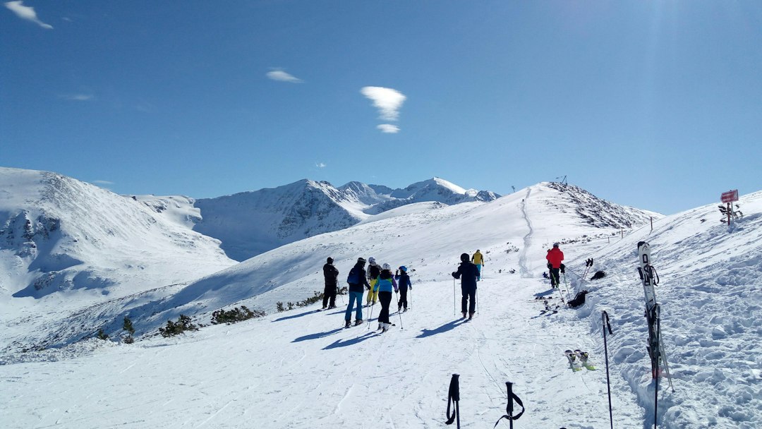 Skiers on a snow-covered Borovets ski slope in Bulgaria