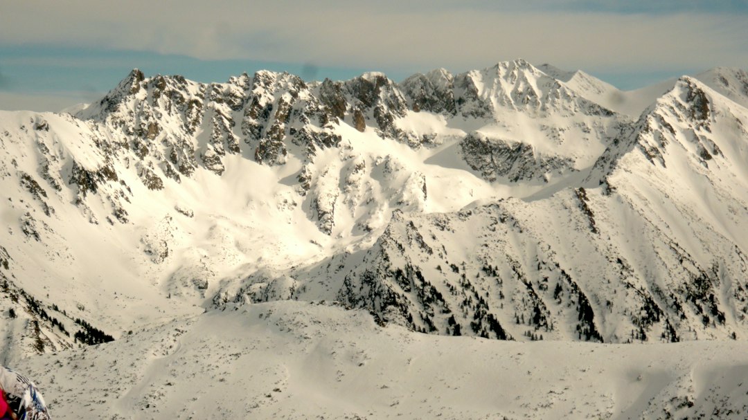 Skiers enjoying a snowy mountain slope in winter