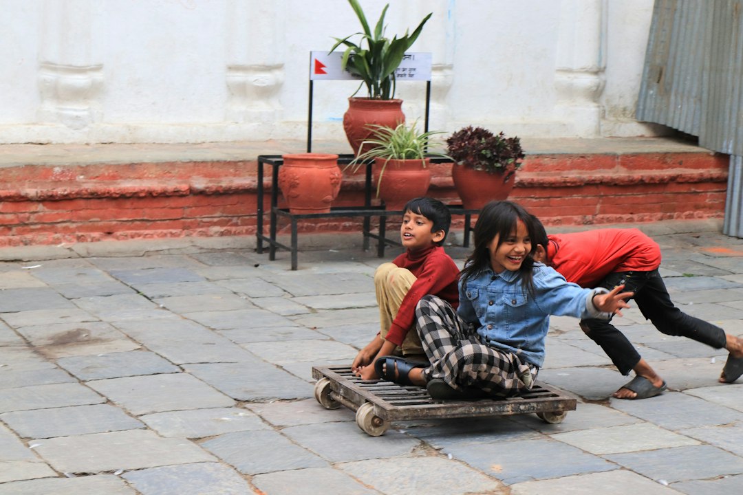 Children playing with a homemade cart