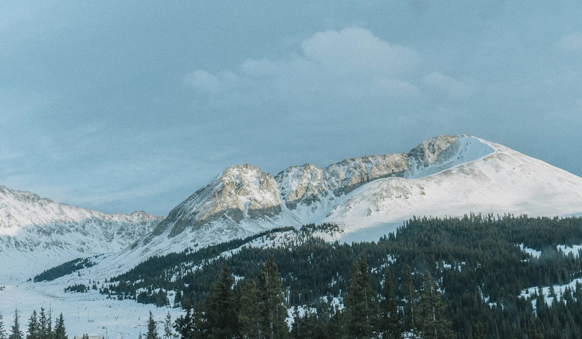 Wide snowy mountain slopes in Colorado under a winter sky