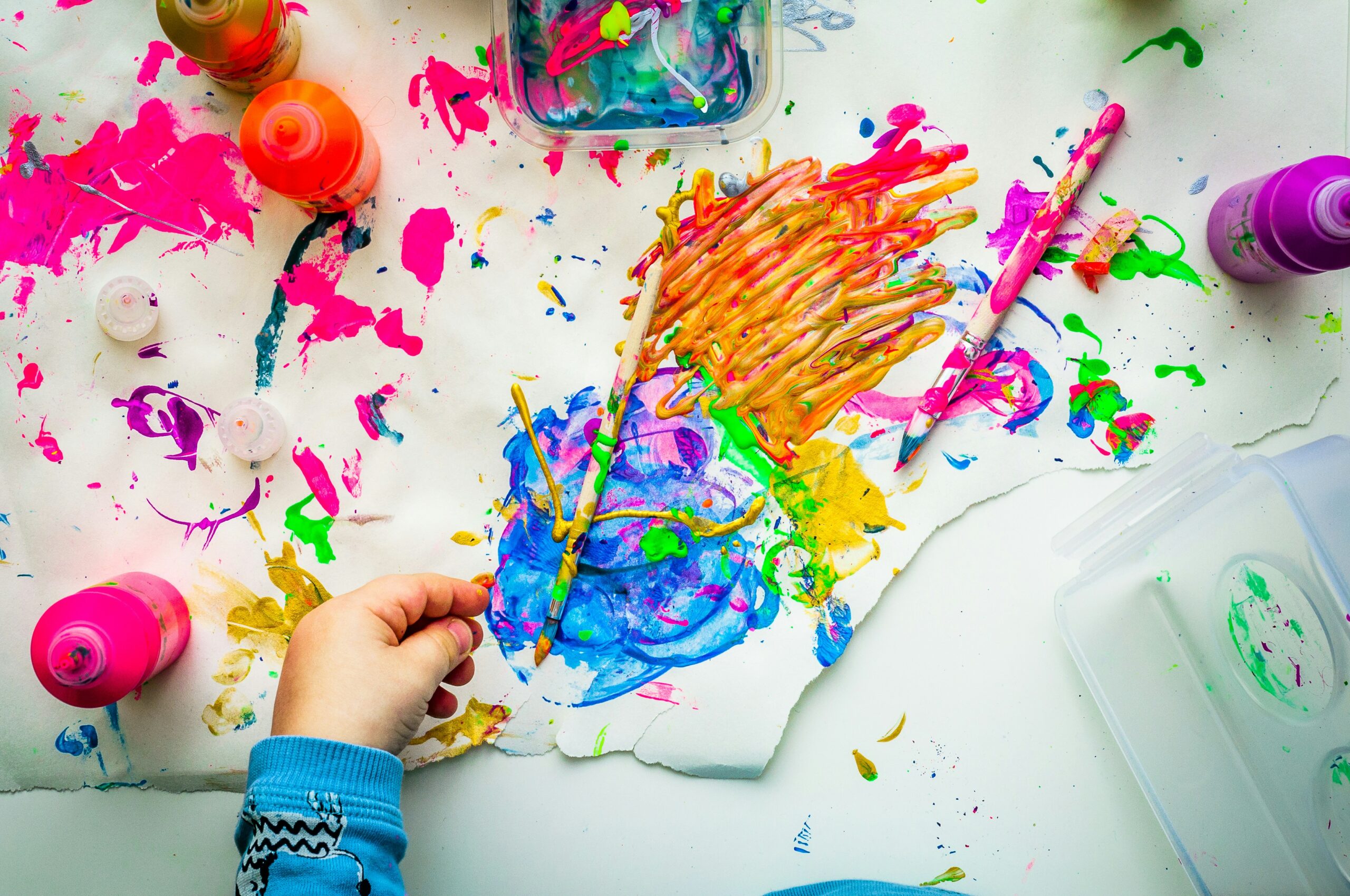 Colorful paintings and creative artwork arranged on a table