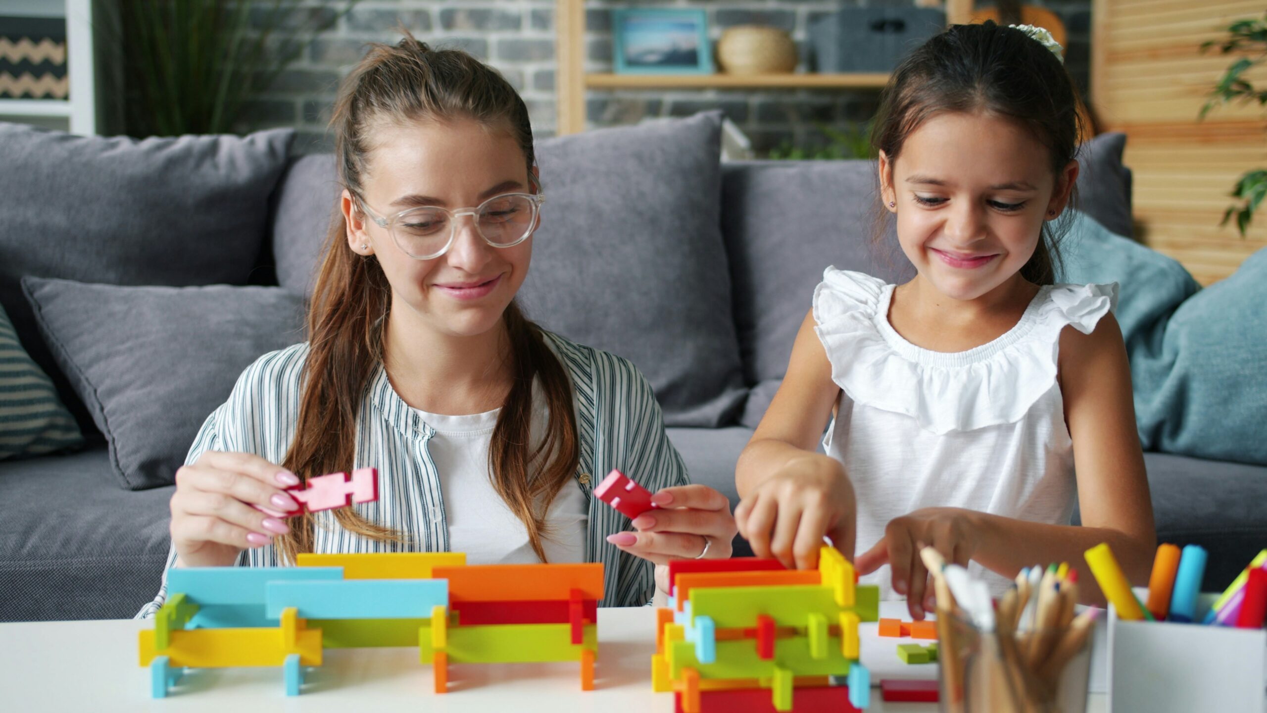 Mother and daughter exploring construction blocks during educational play