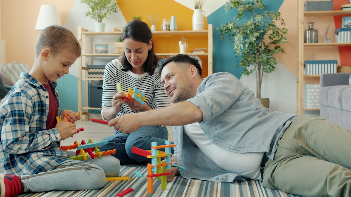Parent and child exploring educational toys together