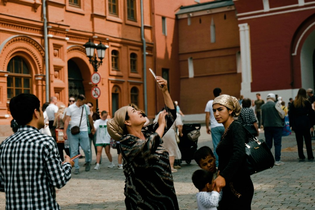 Visitors exploring a historic European city square on a family trip