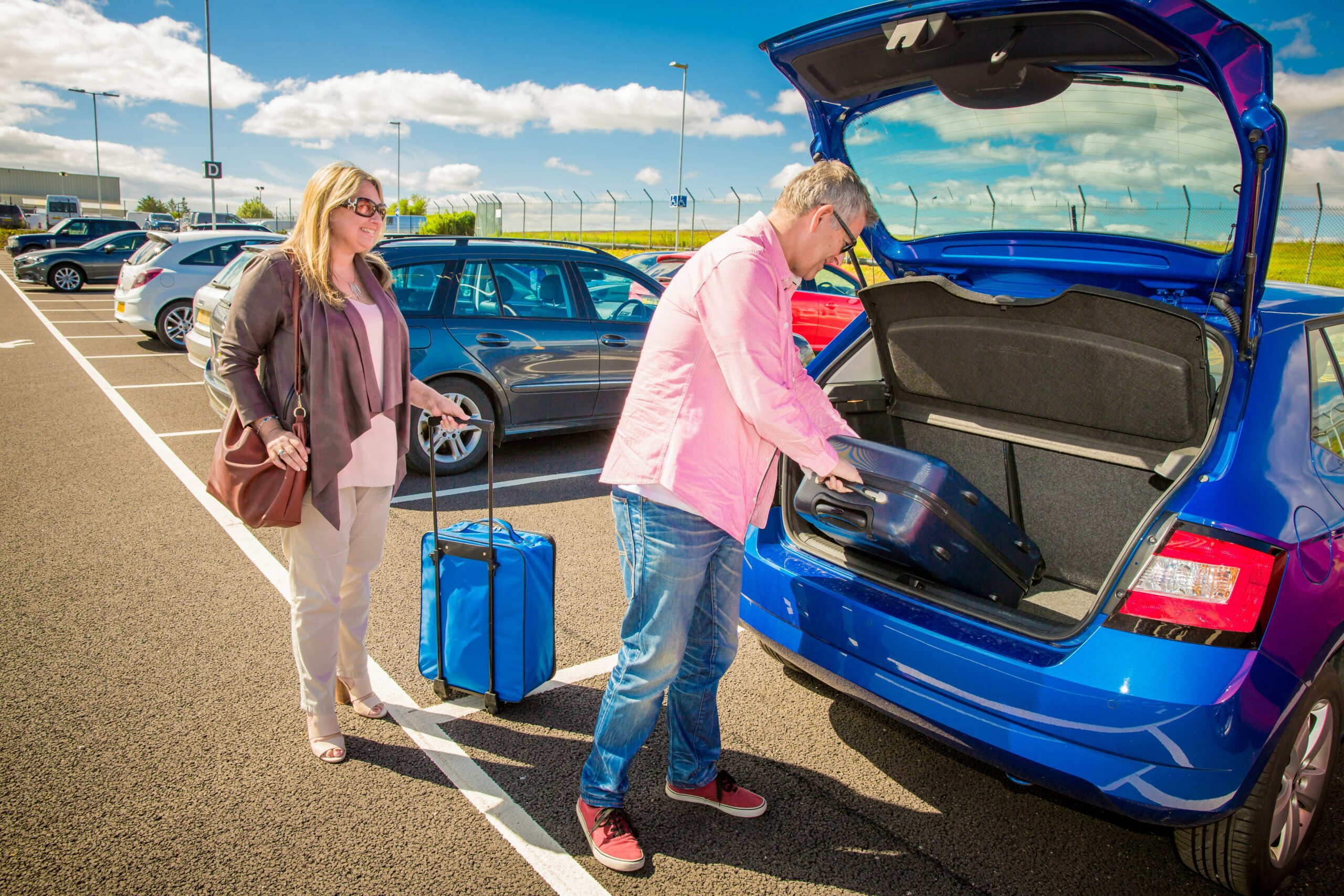 Travellers loading suitcases before leaving for a holiday