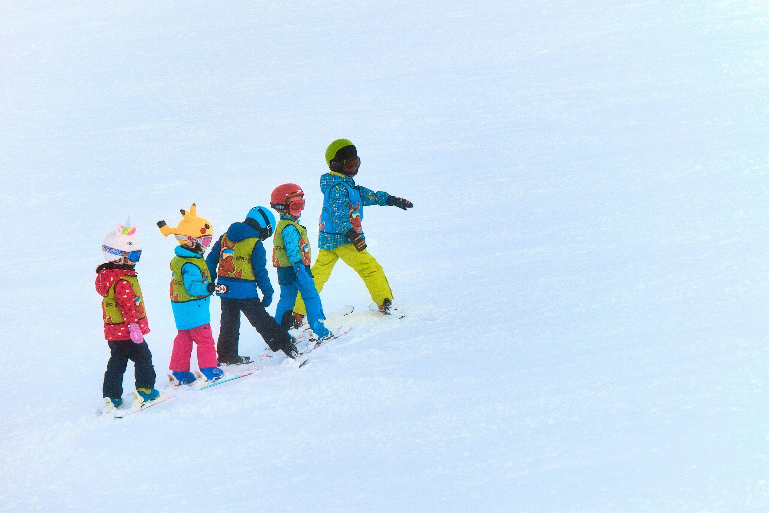 Children skiing together on a snow-covered mountain slope