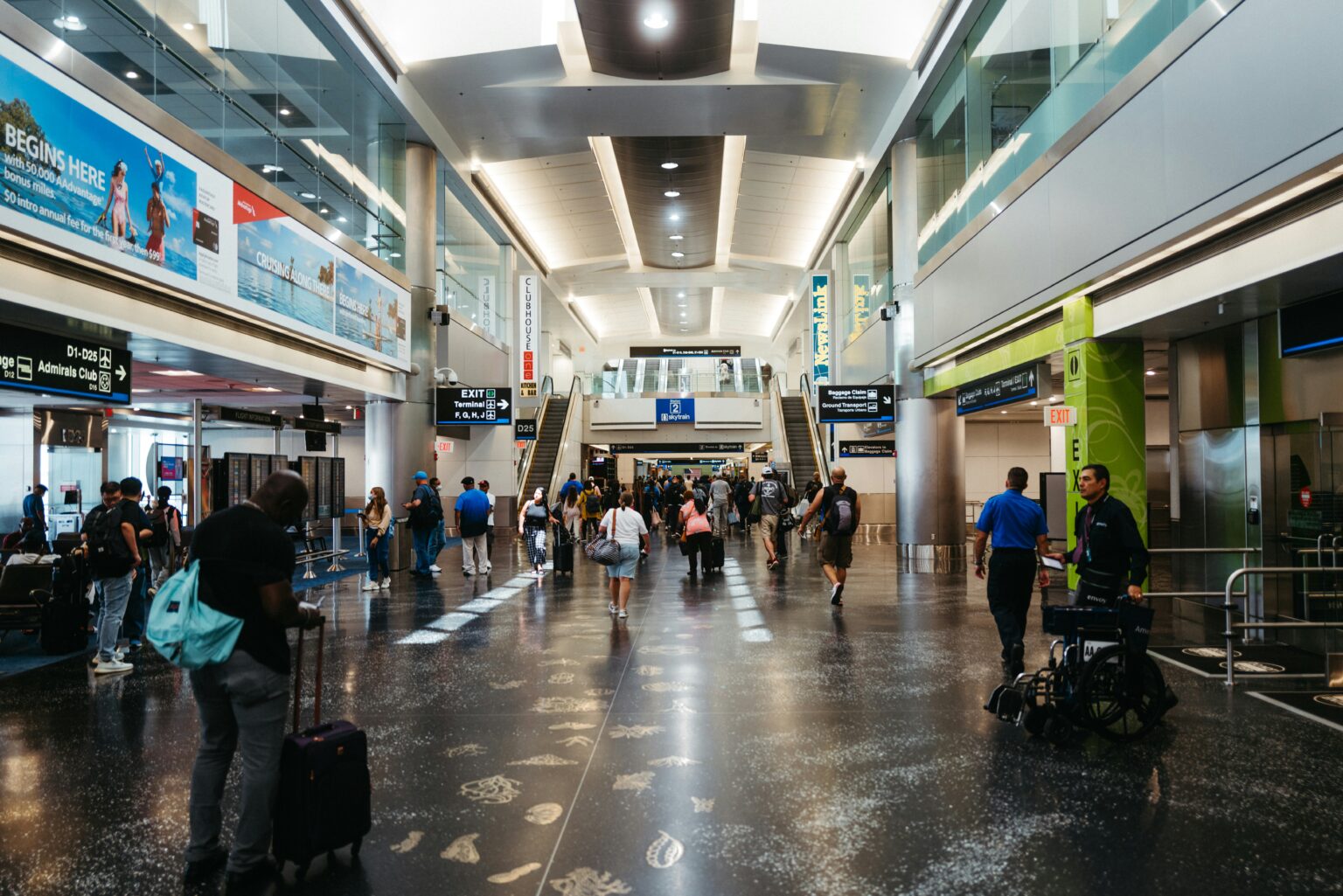 Travelers walking through a busy airport terminal before departure