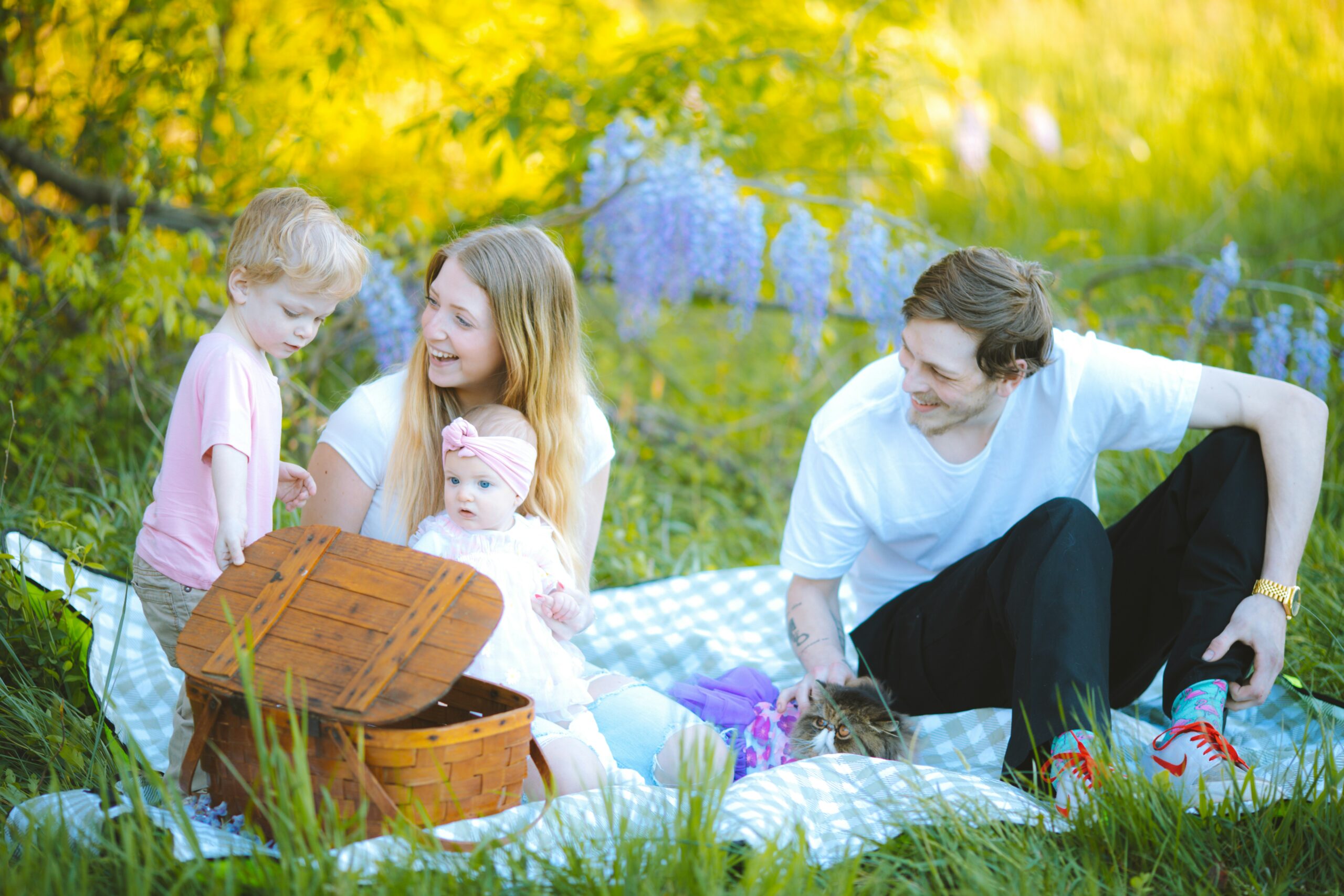 Family spending a relaxed weekend together on a picnic blanket in a park