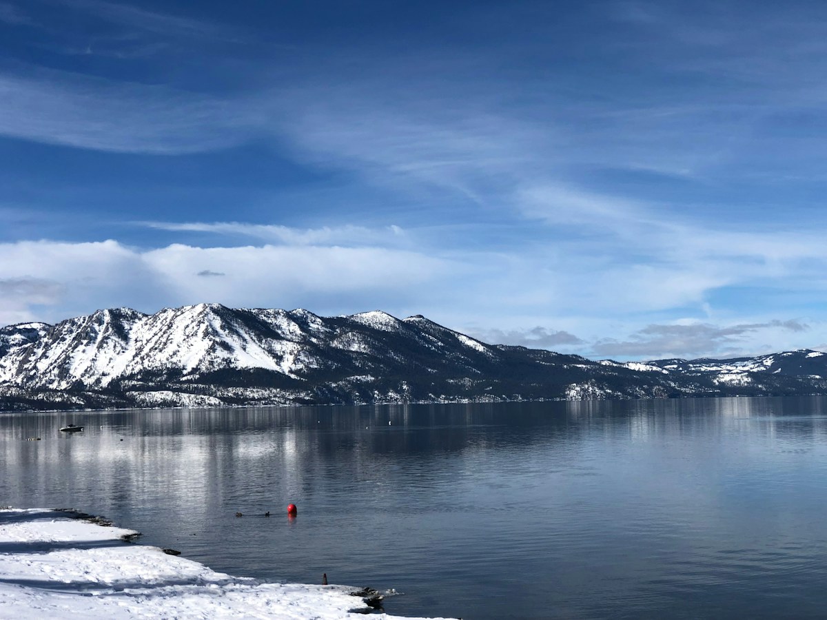 Snow-covered mountains surrounding a winter lake near Lake Tahoe