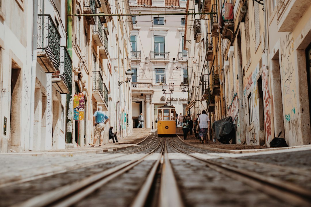 Historic Lisbon street with a traditional yellow tram