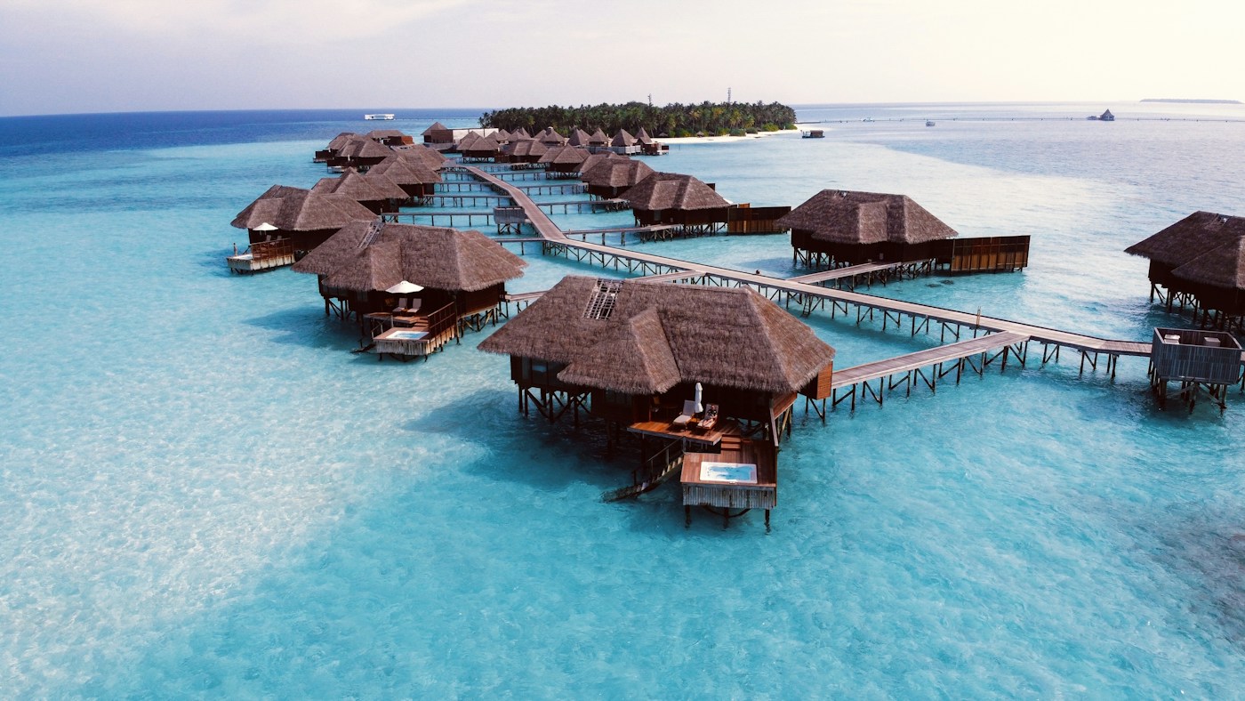 Overwater villas above a turquoise lagoon in the Maldives
