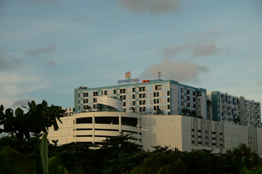 Modern buildings in a tropical Southeast Asian city, illustrating why families should identify nearby medical facilities before travelling
