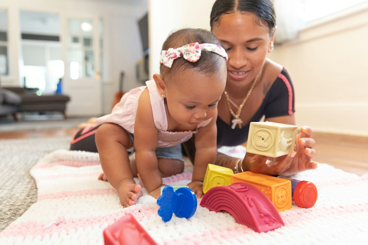 Parent interacting with an infant during floor play
