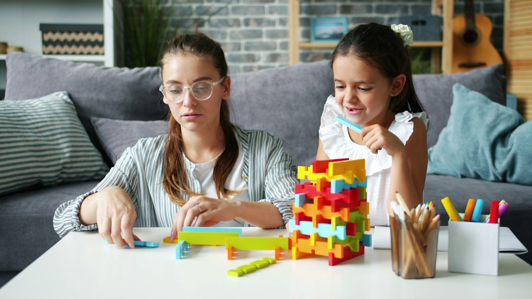 Parent and preschooler building blocks together during focused indoor play