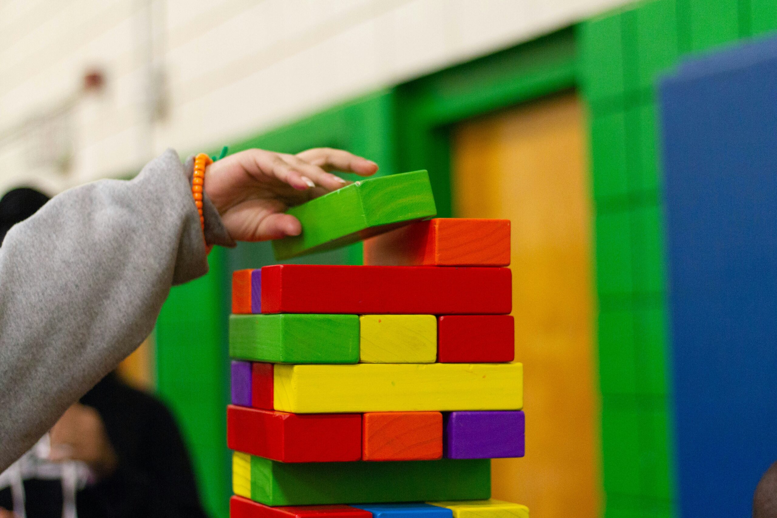 Preschooler sorting colorful toys by color and shape
