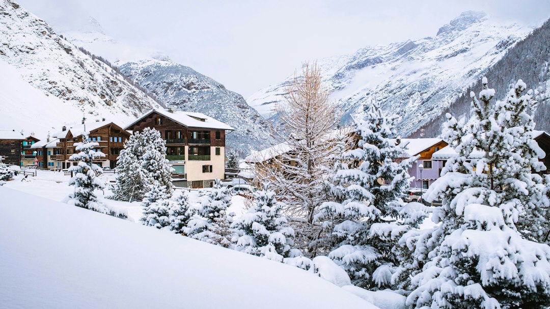A quiet alpine village surrounded by snow-covered mountains