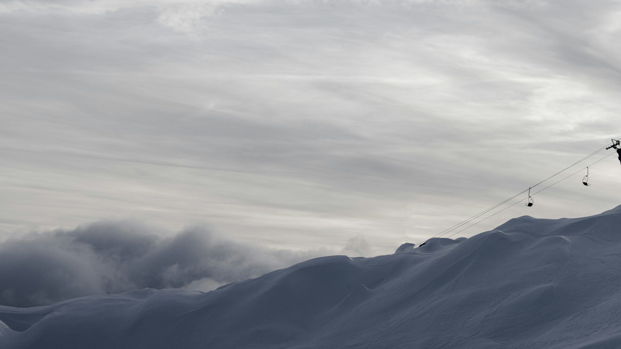 Skier descending a snow-covered Alpine slope in winter