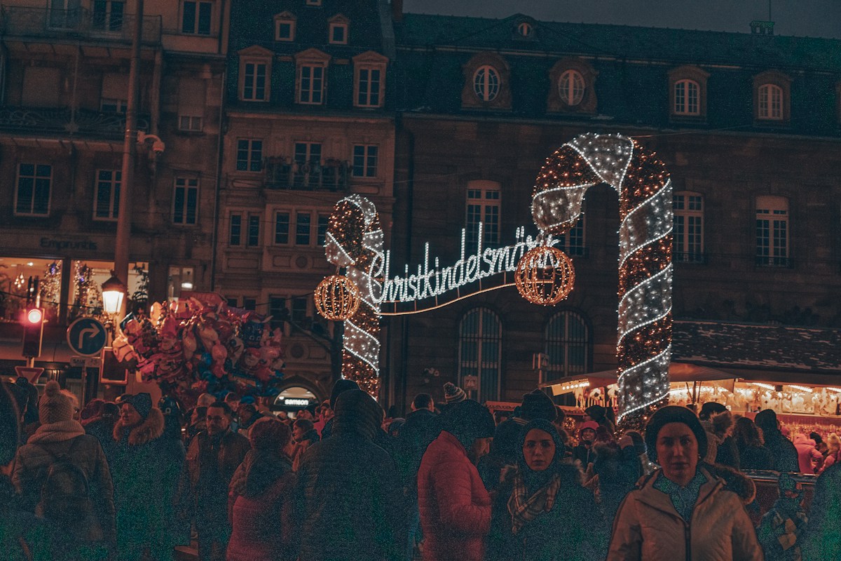 Crowds enjoying a Christmas market among historic buildings in Strasbourg