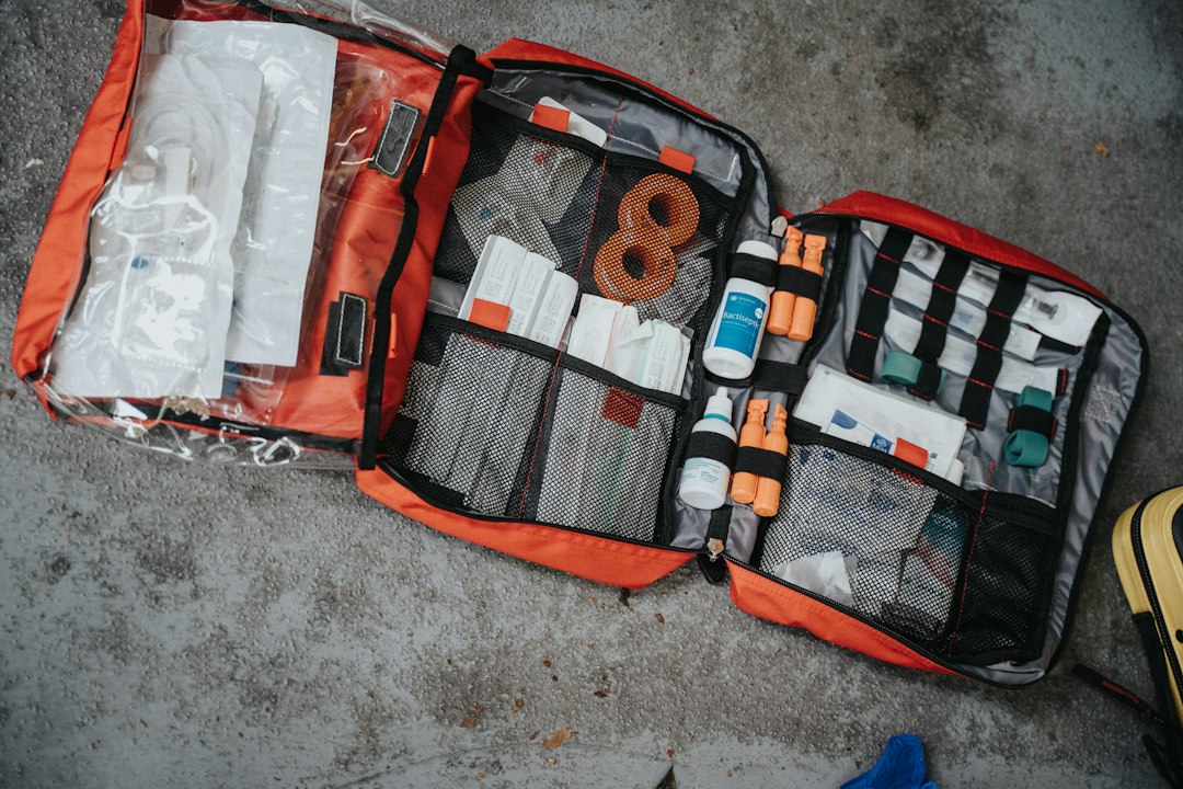 Open first aid kit with medical supplies for travel preparation