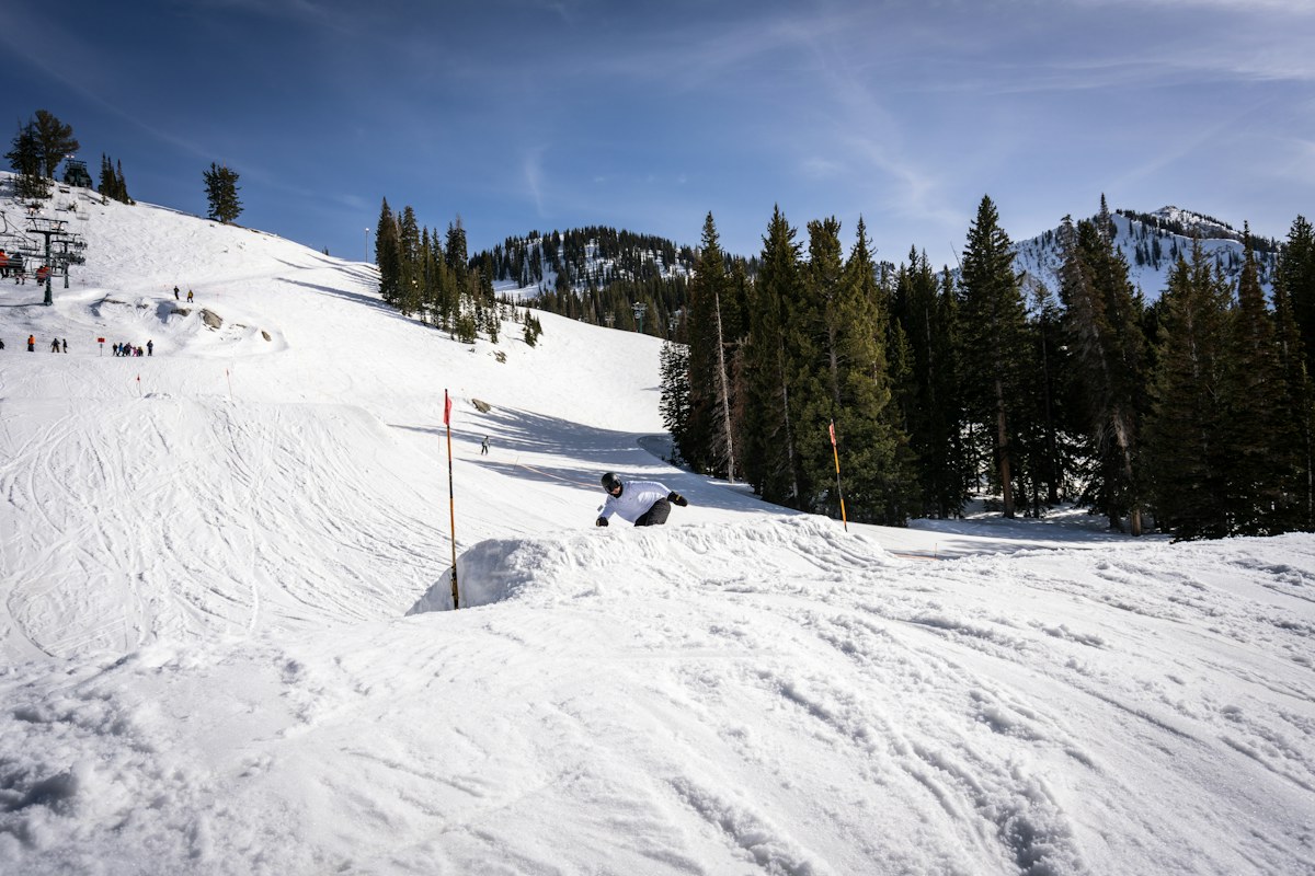 Skier enjoying a sunny day on a snow-covered Utah mountain