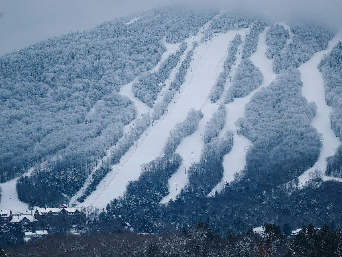 Snowy ski trails winding through a forested mountain in the eastern United States