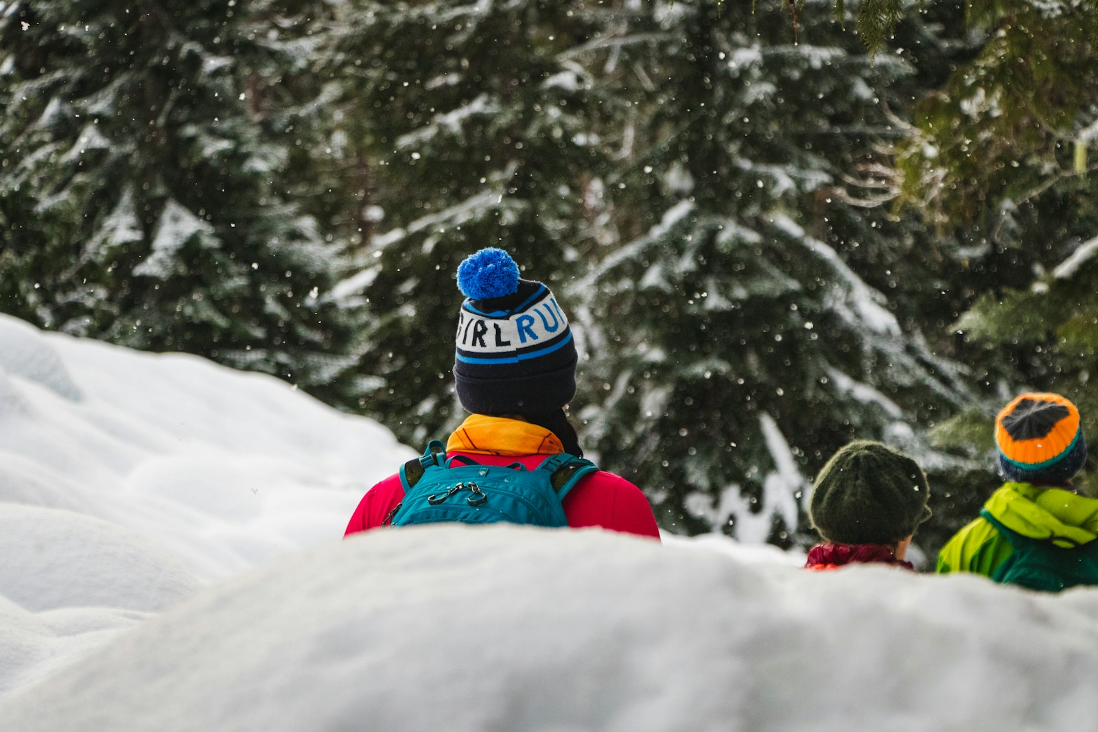 Family walking through a snowy winter forest